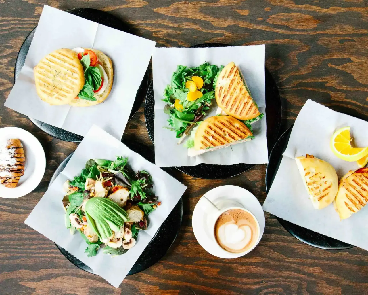 Sandwiches, salads and coffee arranged on a table